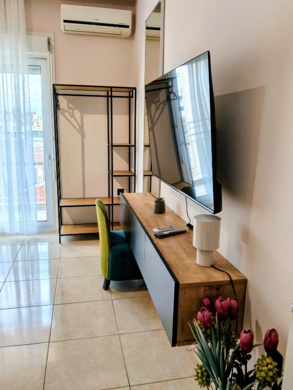 a living room with a television and a desk at Gk Central Studio Xanthi in Xanthi