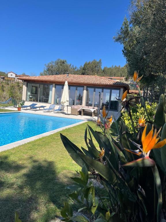 a villa with a swimming pool and a house at The Pool House in Longos