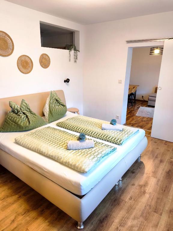 a bedroom with a bed with towels on it at Riverside Appartements in Lieserbrücke