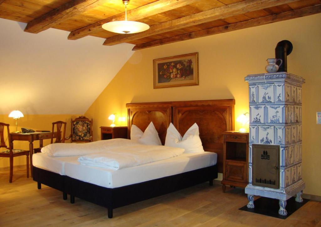 a bedroom with a bed with a wooden headboard at Historisches Genusshotel Löwen in Schopfheim