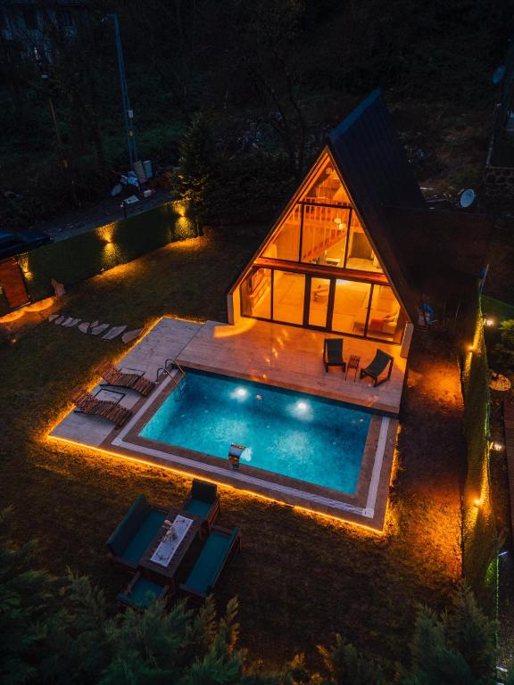 an overhead view of a house with a swimming pool at night at Green date bungalow in Sapanca