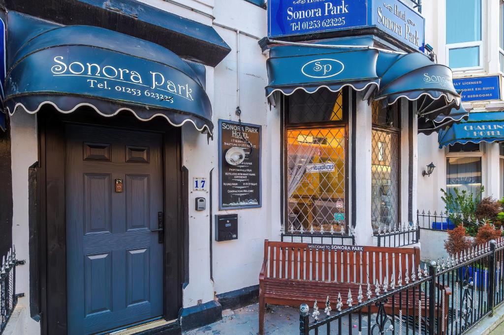a building with a blue door and a bench in front at The Sonora Park Contactless Hotel by BET stays in Blackpool