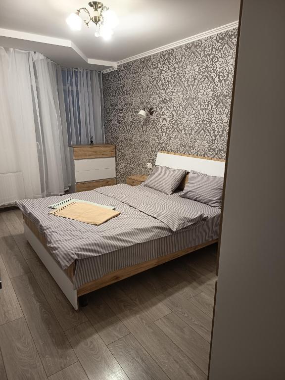 a bedroom with a bed with a wooden floor at SweetHome in Ternopil