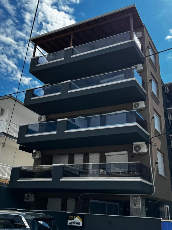 a building with balconies on the side of it at Blue Sea Nest in Paralia Katerinis