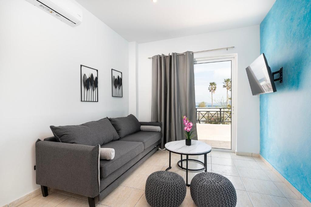 a living room with a couch and a table at Azure Edge - Seafront View - Beach Stay in Tigaki
