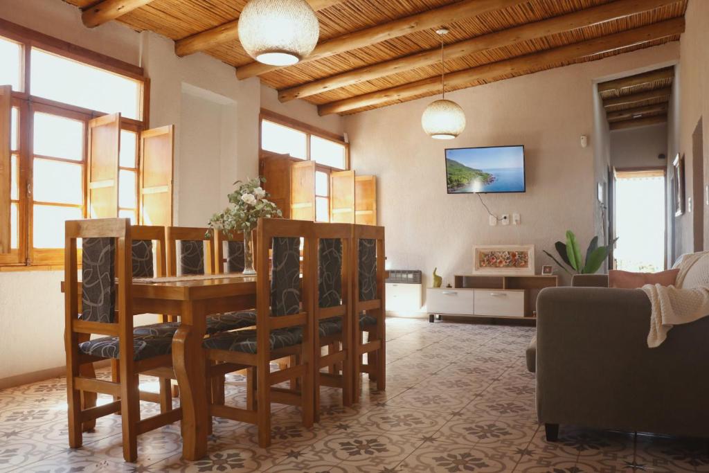 a living room with a wooden table and chairs at El Rancho , casa de huéspedes in Tupungato