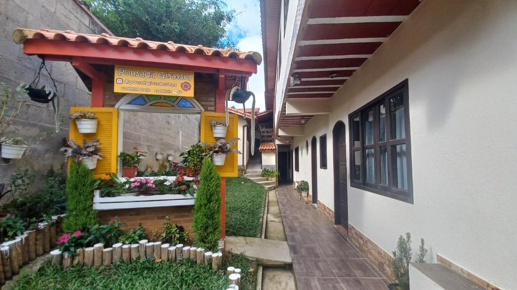 a building with a sign on the side of it at Pousada Girar do Sol in Nova Friburgo