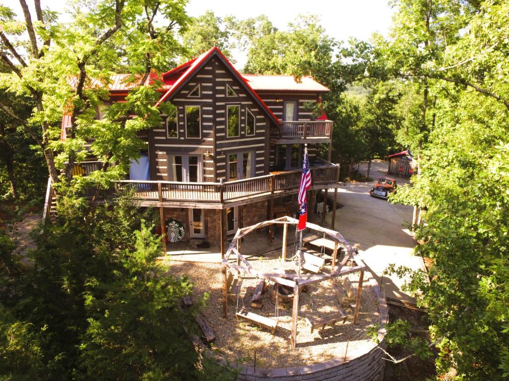 a large house with a playground in front of it at Tranquility Cove Lodge in Dandridge