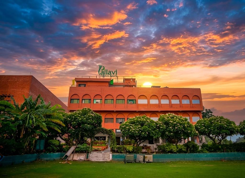 a building with a sign on top of it at sunset at Hotel Pallavi Grand in Panchkula