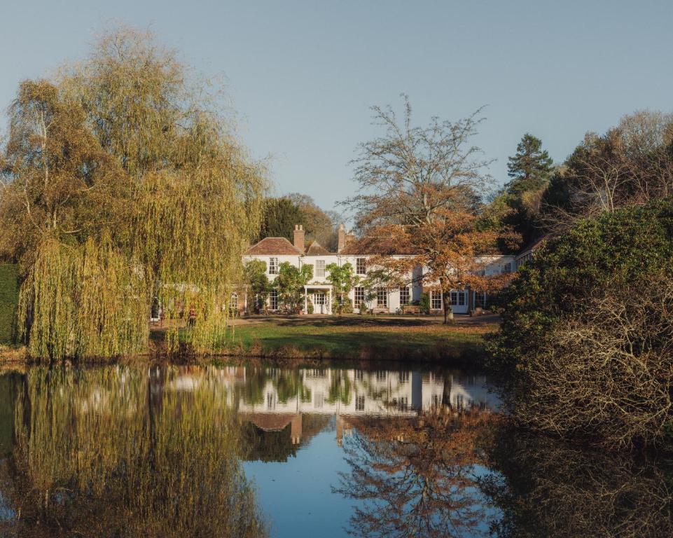 a house next to a lake in front of a house at Crafted at Powdermills in Battle