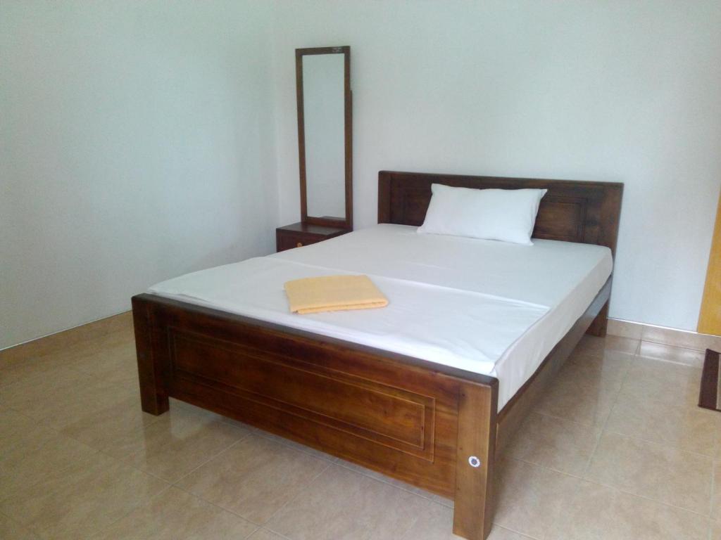 Postel nebo postele na pokoji v ubytování Diyawara Home Stay