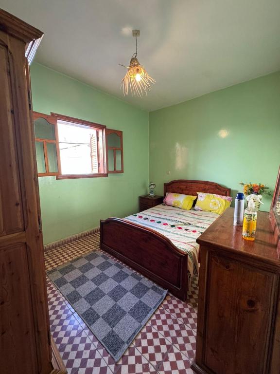 a bedroom with a bed with a checkered floor at Love Wave House in Agadir