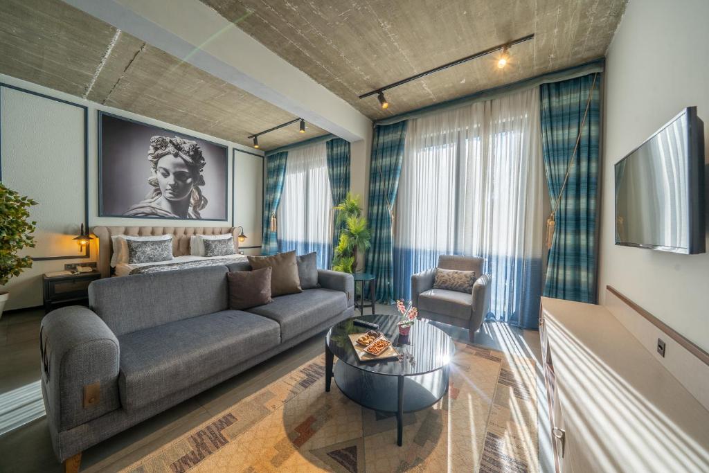 a living room with a couch and a table at Sandora Boutiuqe Hotel in Yalıkavak