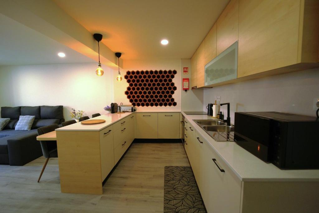 a kitchen with a couch and a table in a room at Casa Ti Madalena in Arganil