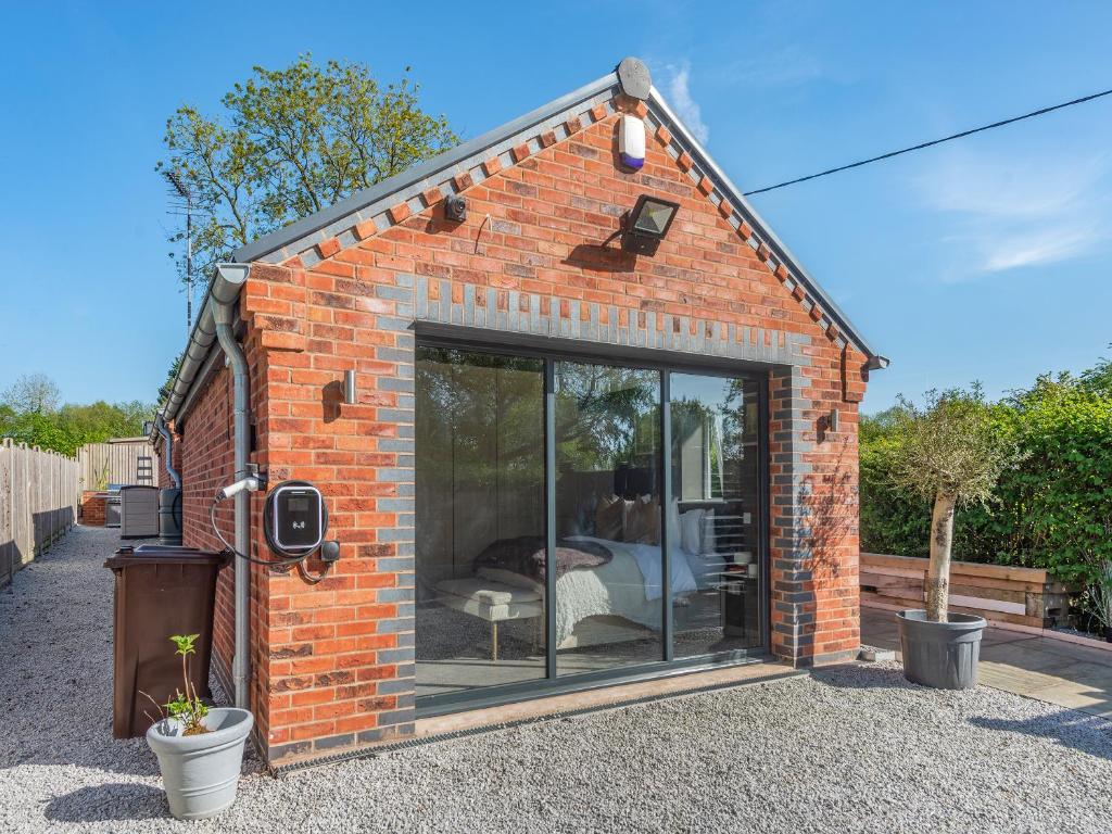 a small brick house with a large glass window at Lower Peastocking in Meriden