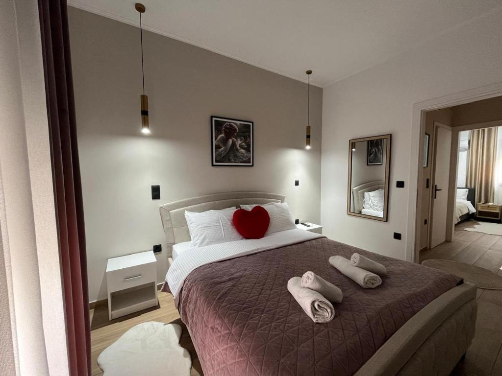 a bedroom with a bed with two towels on it at Apartment Debrova in Alexandroupoli