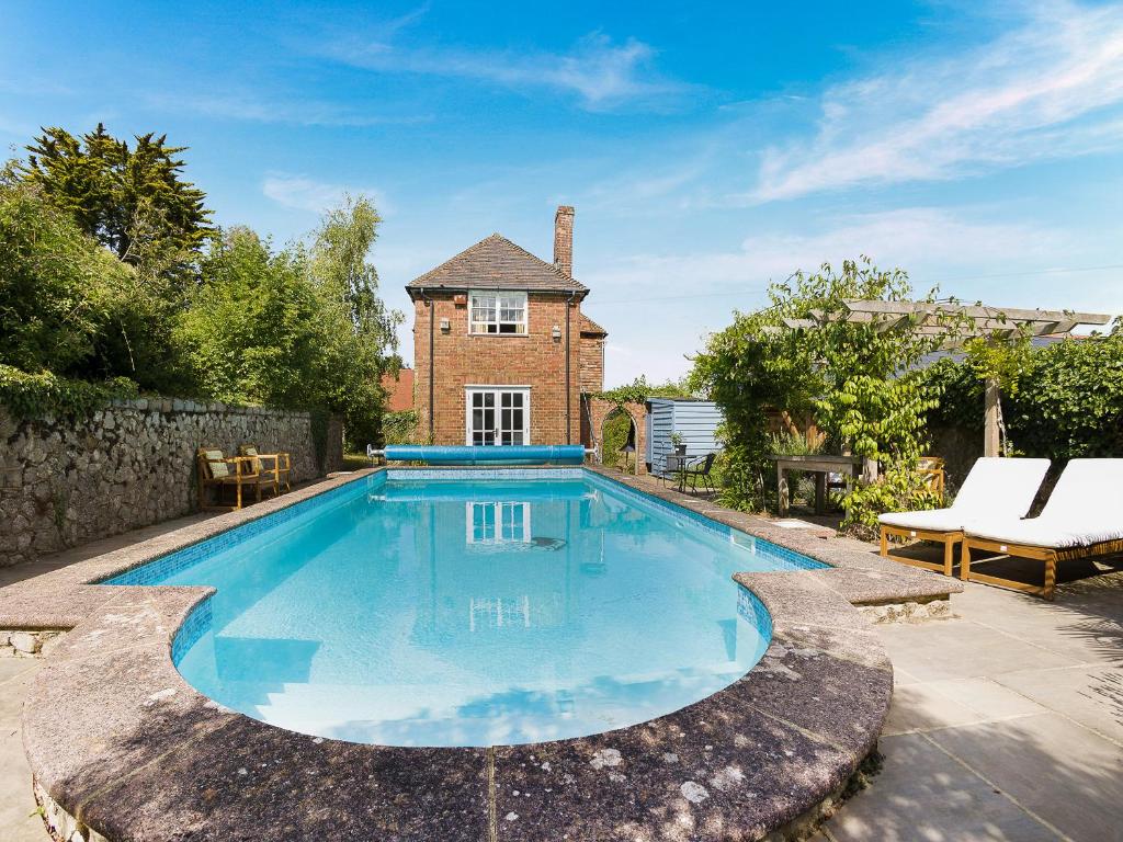 a swimming pool in the backyard of a house at Linnet - Uk50154 in Faversham