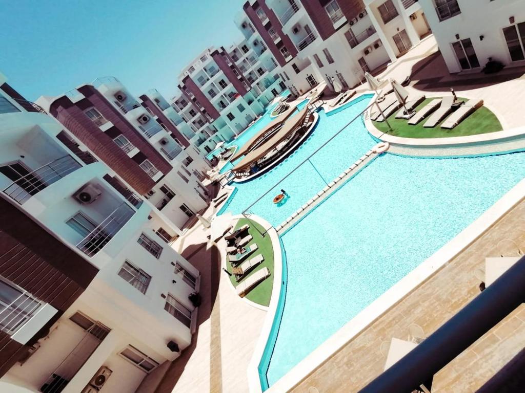 a view of a swimming pool in the middle of a building at Aqua Palms Resort D101 in El Gouna