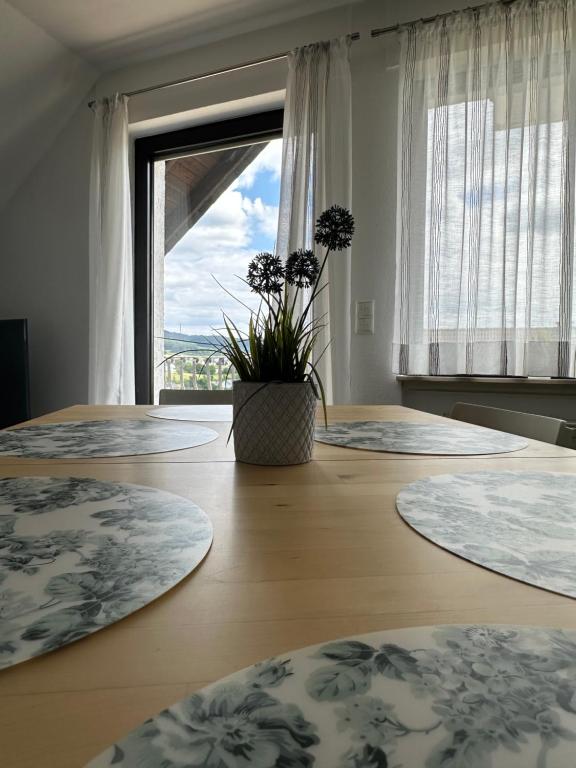 a room with three tables with a large window at Ferienhaus Talblick in Kelberg