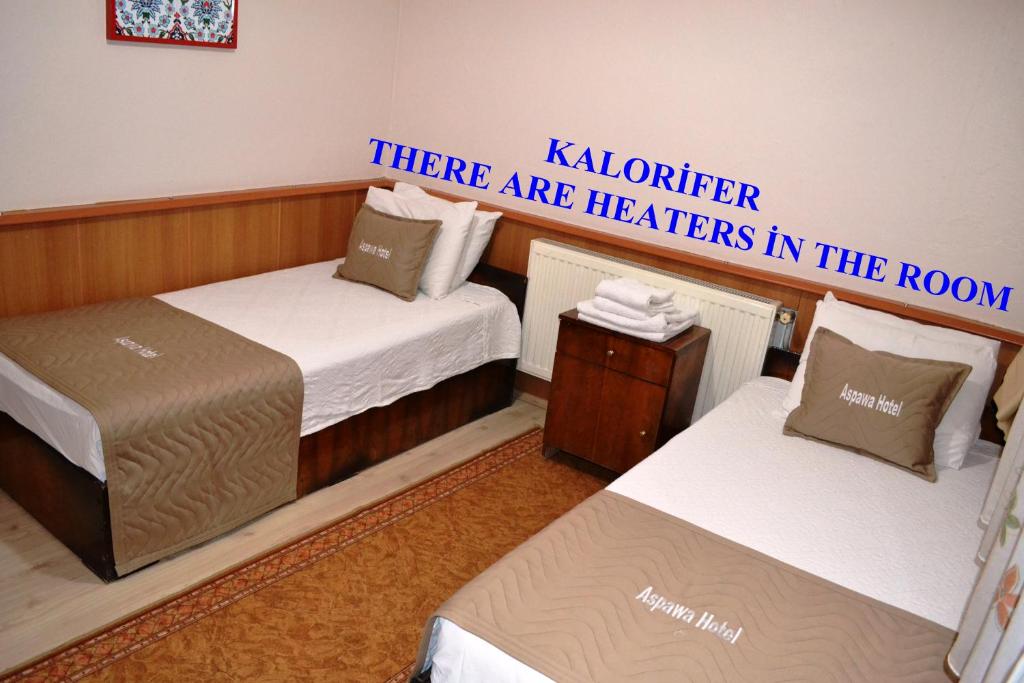 A bed or beds in a room at Aspawa Hotel