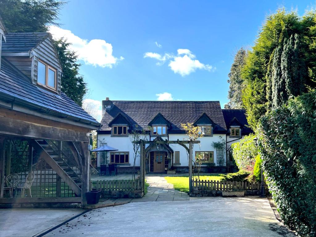 a large white house with a gate and fence at The Oaks in Blackburn