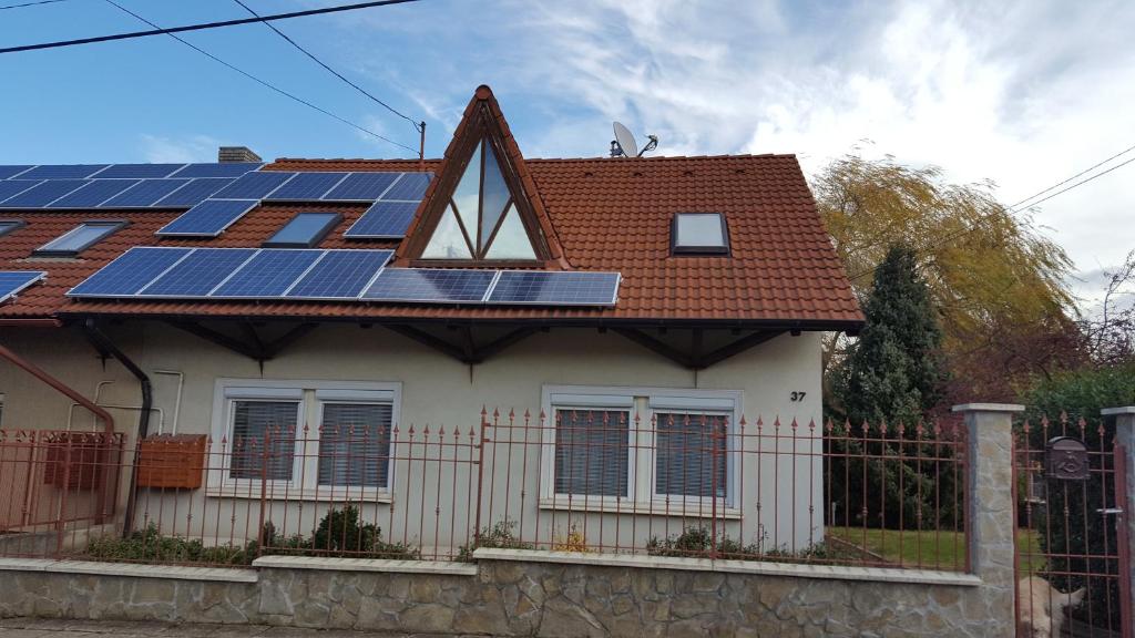 a house with solar panels on the roof at Veszprém Room in Veszprém
