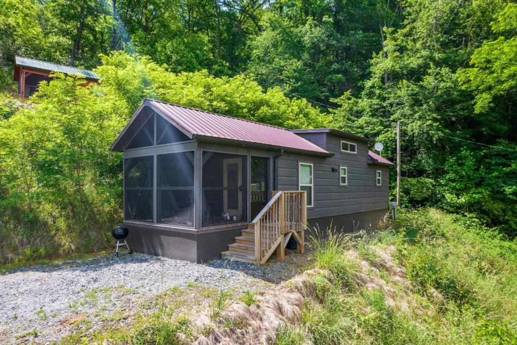 a small cabin in the middle of a forest at Smoky Mountain Mist, Tiny House, Custom Log Cabin in Bryson City