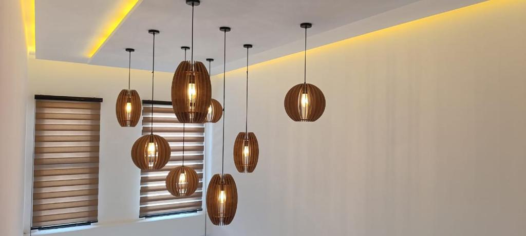a group of brown lights hanging from a ceiling at Villa AM in Awlād ‘Umar