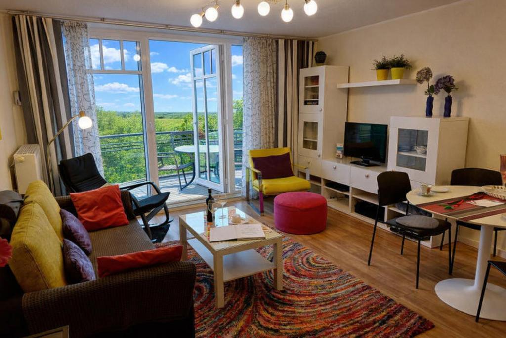 a living room filled with furniture and a large window at de Dang in Dorum-Neufeld