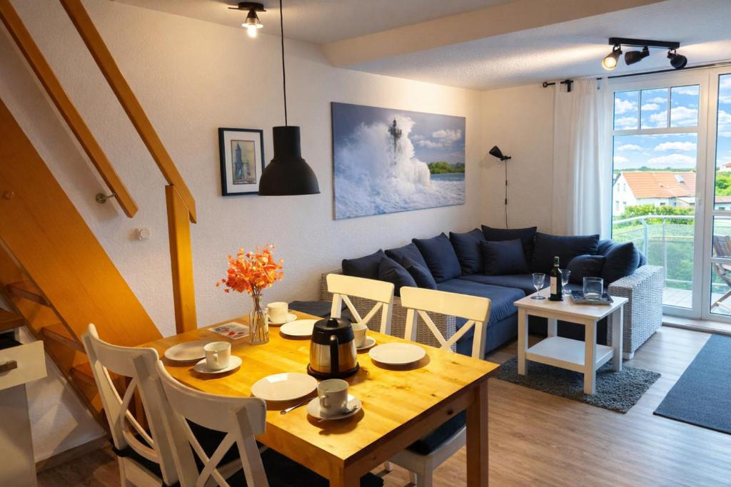 a living room with a table and a blue couch at de Spree in Dorum-Neufeld