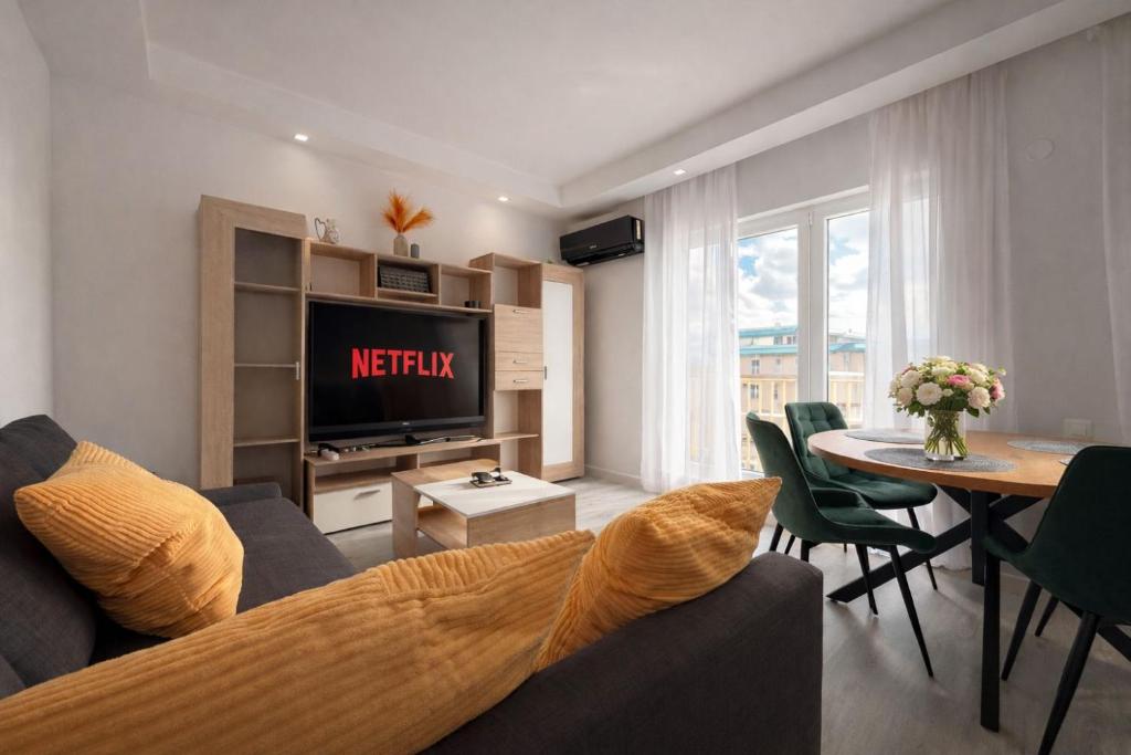 a living room with a couch and a table at Jupiter Suite #6people in Ştefăneştii de Sus