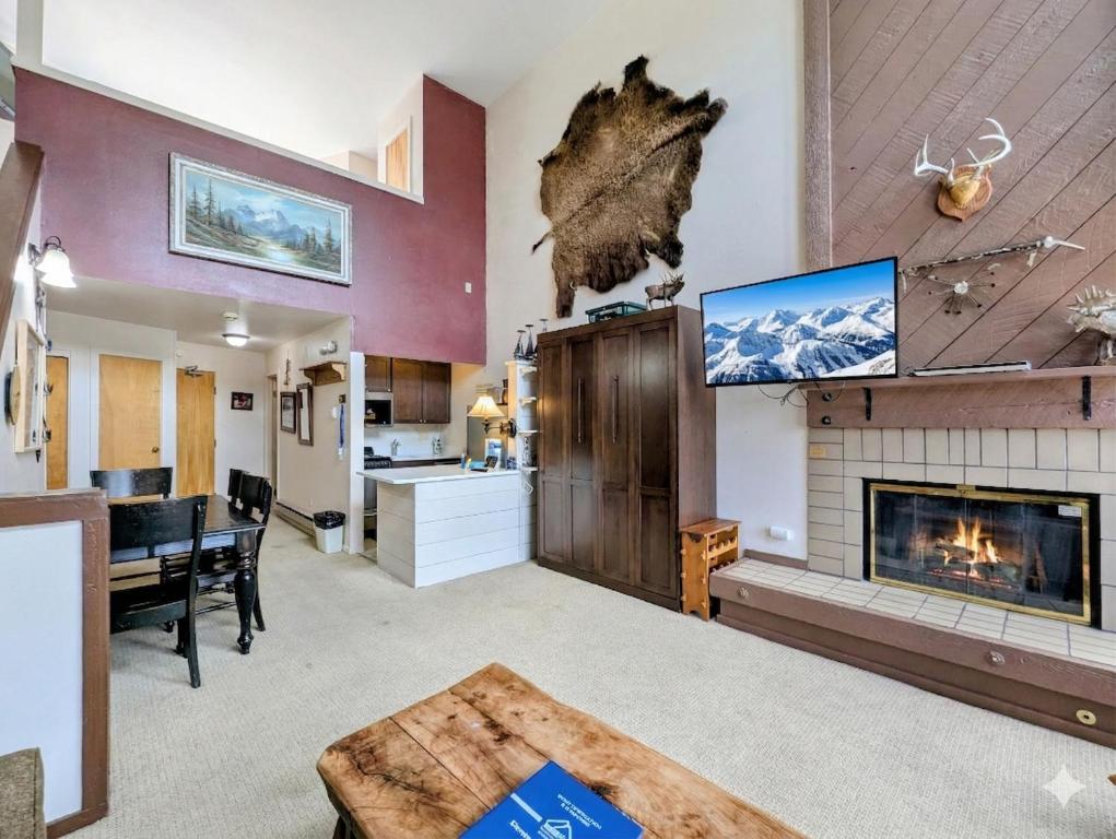 a living room with a fireplace and a tv at Edgewater 1448 by SummitCove Lodging in Colorado in Keystone