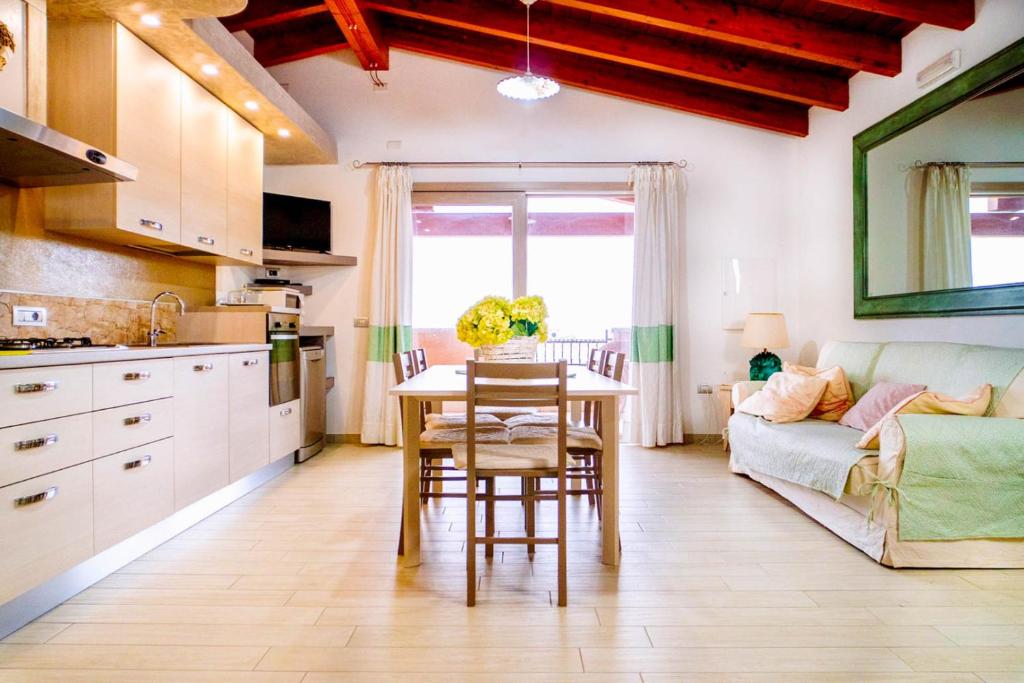 a kitchen and living room with a table and a couch at Villa Chia 2 in Chia