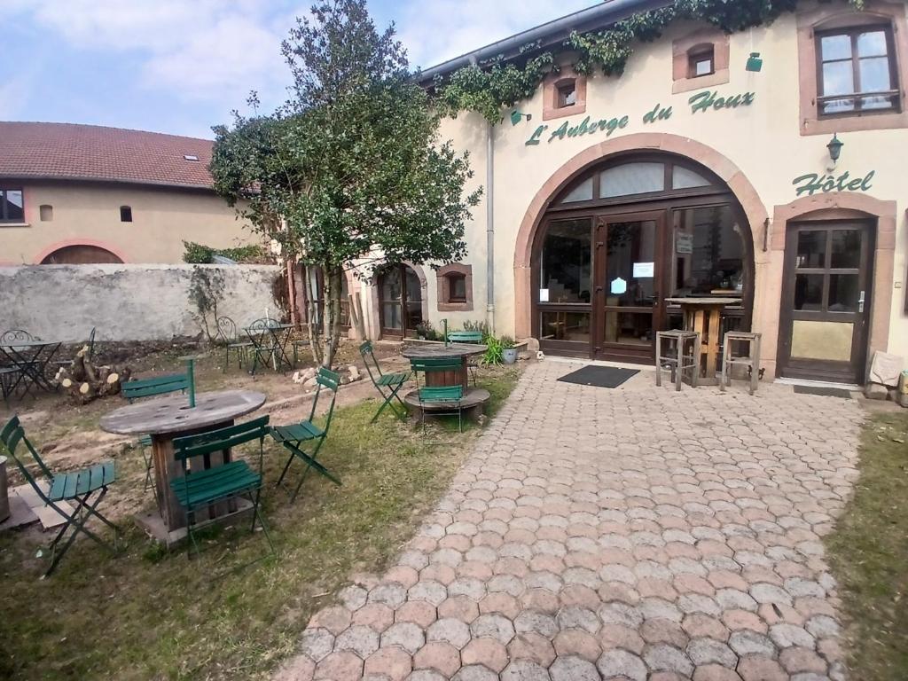 a building with a table and chairs in front of it at L'auberge du Houx in La Houssière