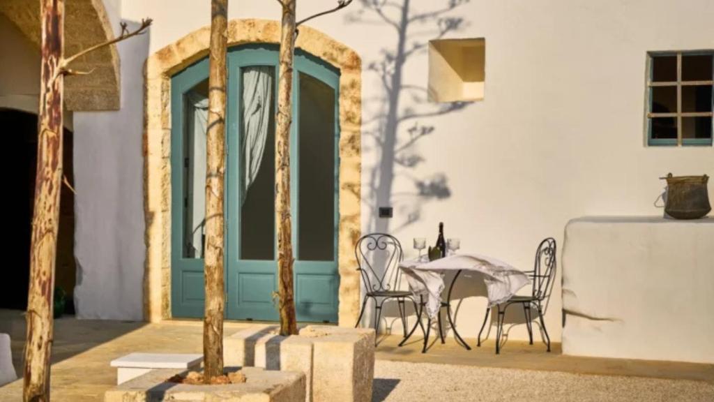 a patio with a table and chairs in front of a building at Bambarone L'Agriturismo in Fasano