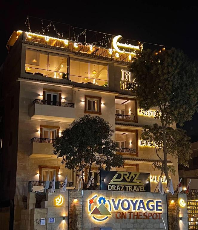 a building with a sign in front of it at night at Voyage On The Spot in Cairo