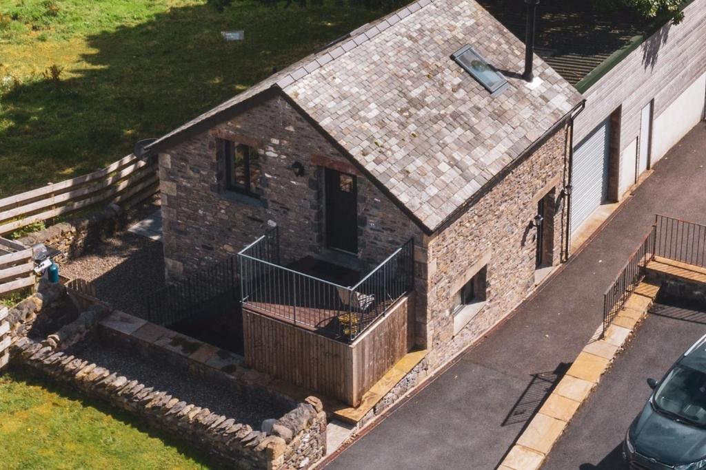 an aerial view of a brick house with a balcony at Barneys cottage with hot tub in the Lake District National Park in Lake District National Park