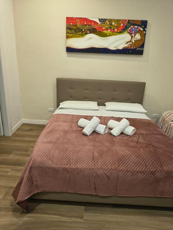 a bedroom with a bed with two towels on it at CASA Di EDO in Brindisi