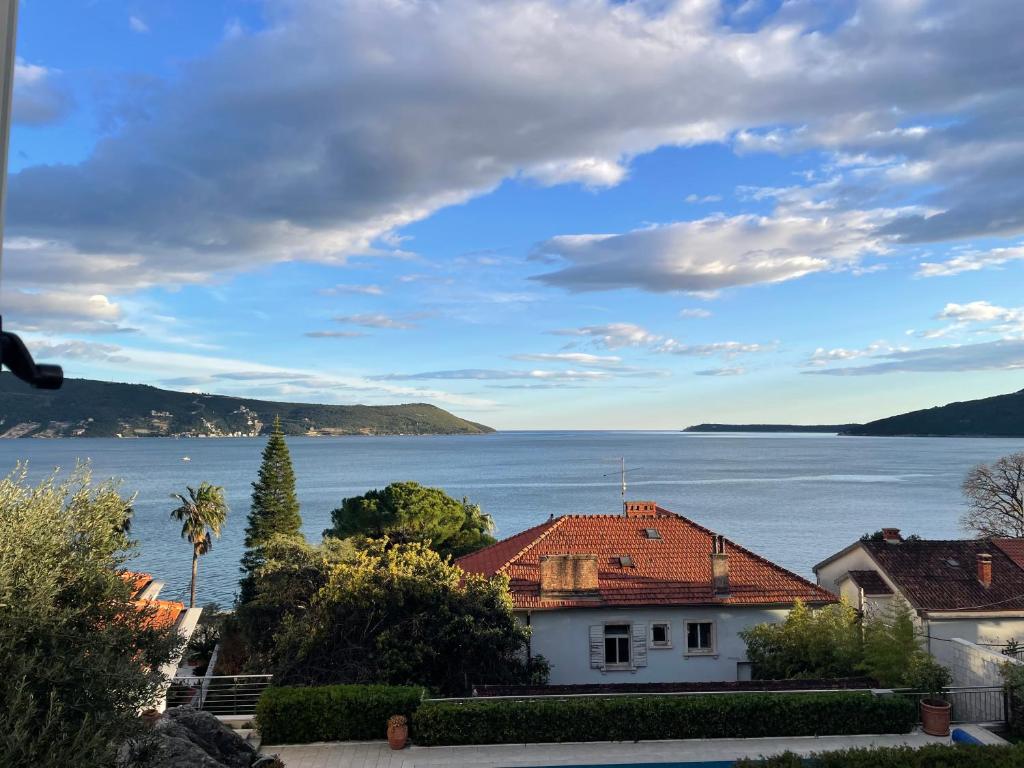 a house with a view of the water at Boka view Heritage Apartment in Herceg-Novi