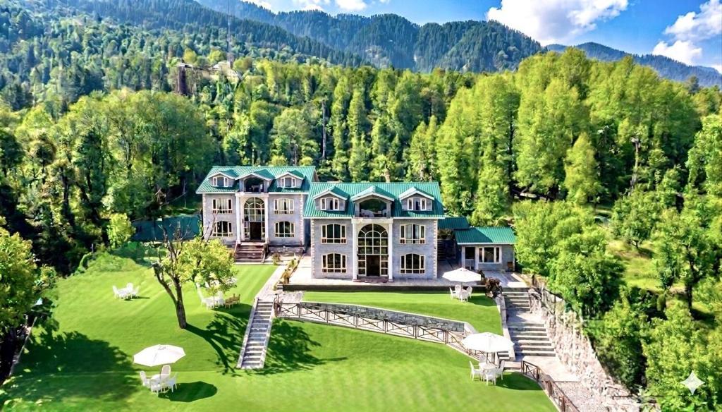 an aerial view of a large house in the mountains at Forest Hill Resorts in Pahalgām