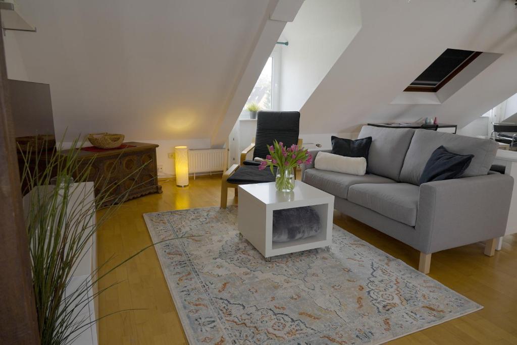 a living room with a couch and a table at Dachgeschosswohnung in Hannover