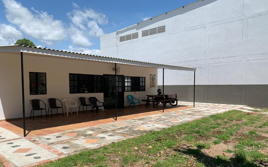 a patio with a table and chairs next to a building at Cabaña AWA in Puerto Salgar