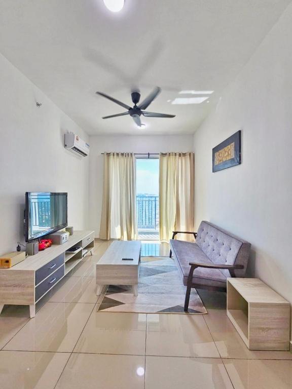 a living room with a couch and a ceiling fan at Metropol Holiday Suite in Bukit Mertajam