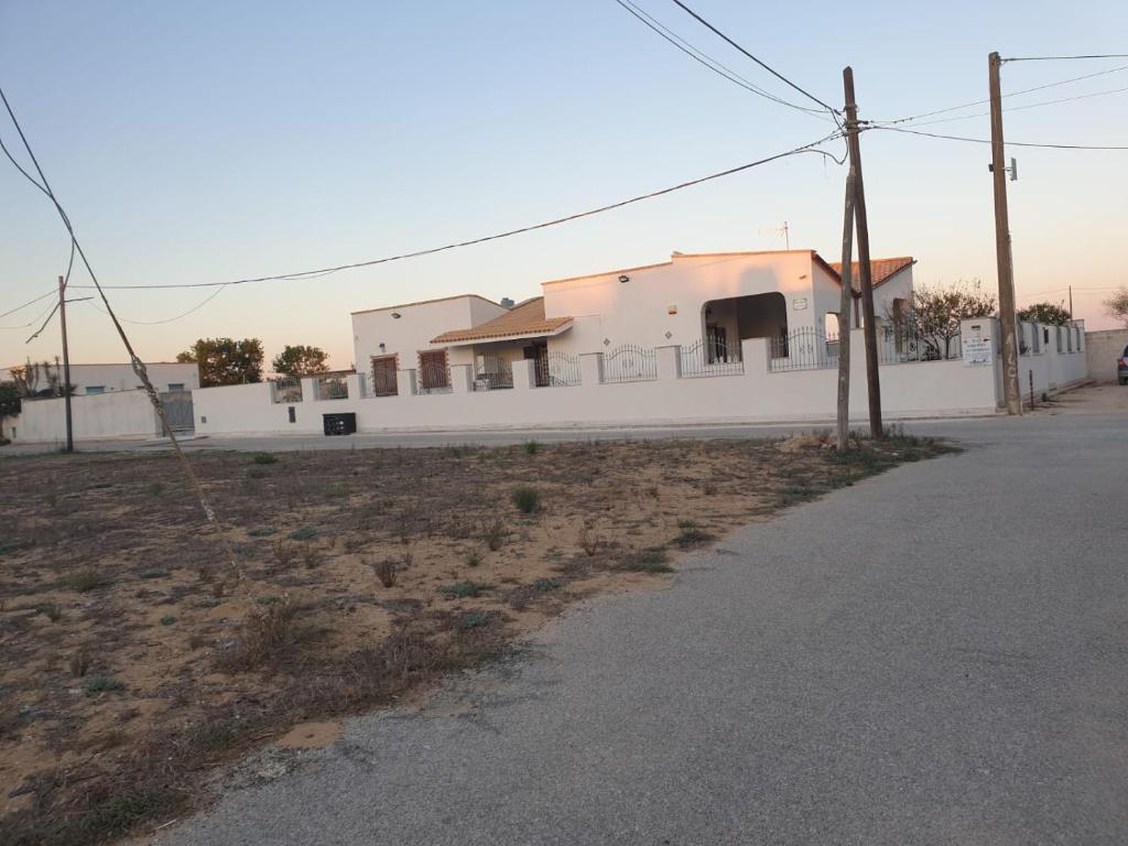 a white building on the side of a street at Villa Maria in Campobello di Mazara