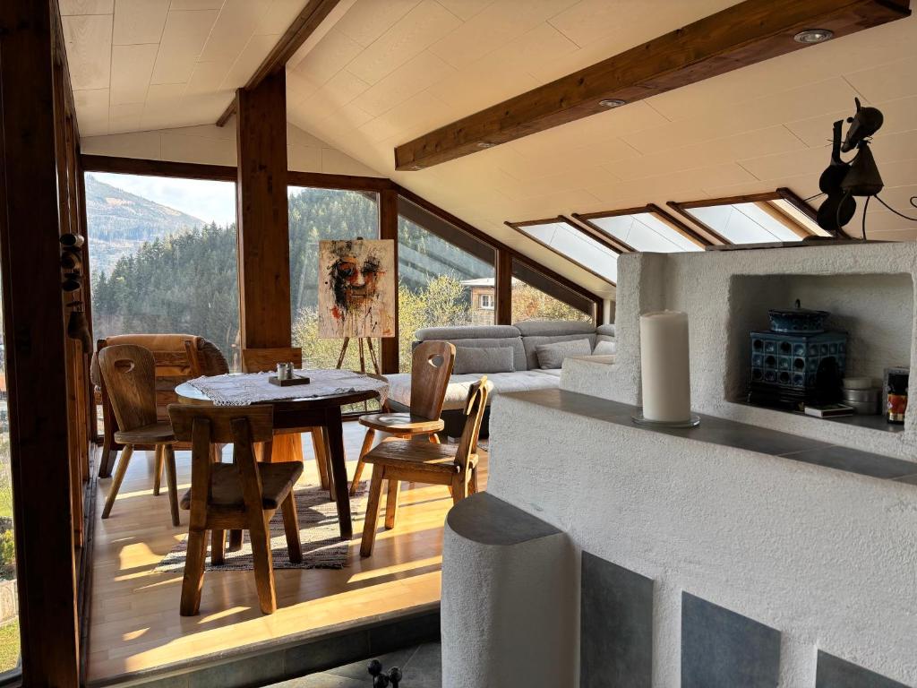 a living room with a table and chairs on a balcony at Appartement Blickfang in Bruck an der Mur