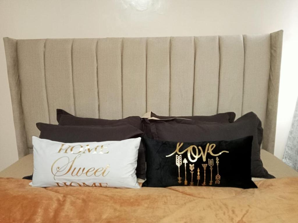 a bunch of pillows sitting on a bed at Kaisa Gardens in Nairobi