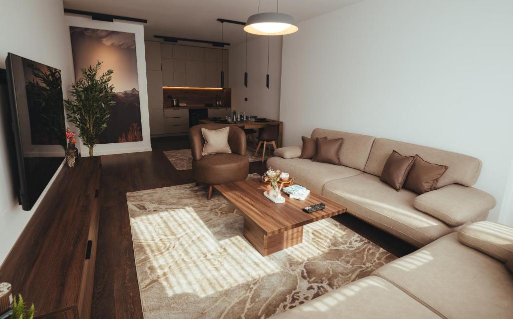 a living room with a couch and a coffee table at A-Apartment in Gjakove