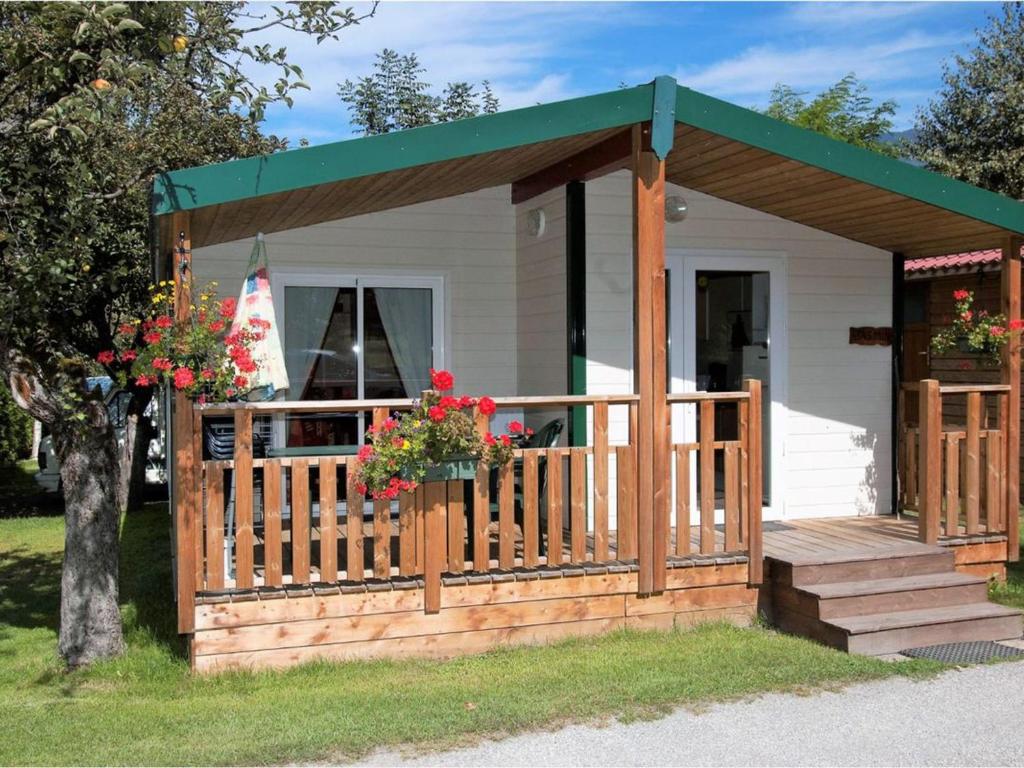 a tiny house with a porch and a deck at Chalet confortable avec terrasse - 6 pers. - API-1-52-2004 in Saint-Oyen