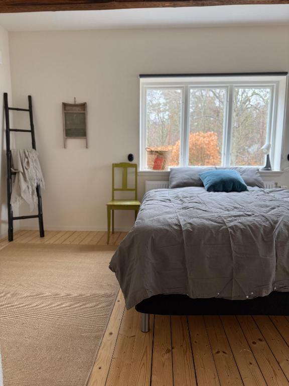 a bedroom with a large bed and a window at Fiskarhuset seaside cottage 2-6 pax in Sjöbo