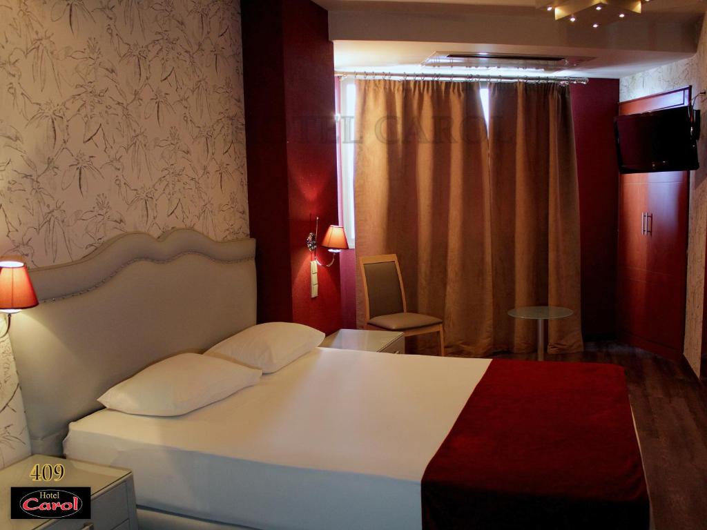 Postel nebo postele na pokoji v ubytování Carol Hotel